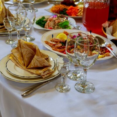 Stół udekorowany na przyjęcie z potrawami przygotowanymi na catering weselny.